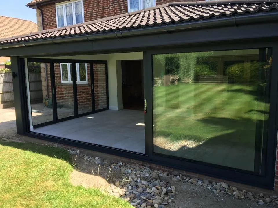 Rear extension with anthracite bi-fold doors opening onto the garden, built by Locks Heath Builders in Hampshire